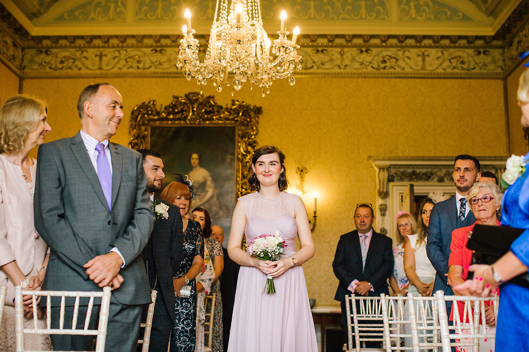 bridesmaid walking down aisle at arley hall