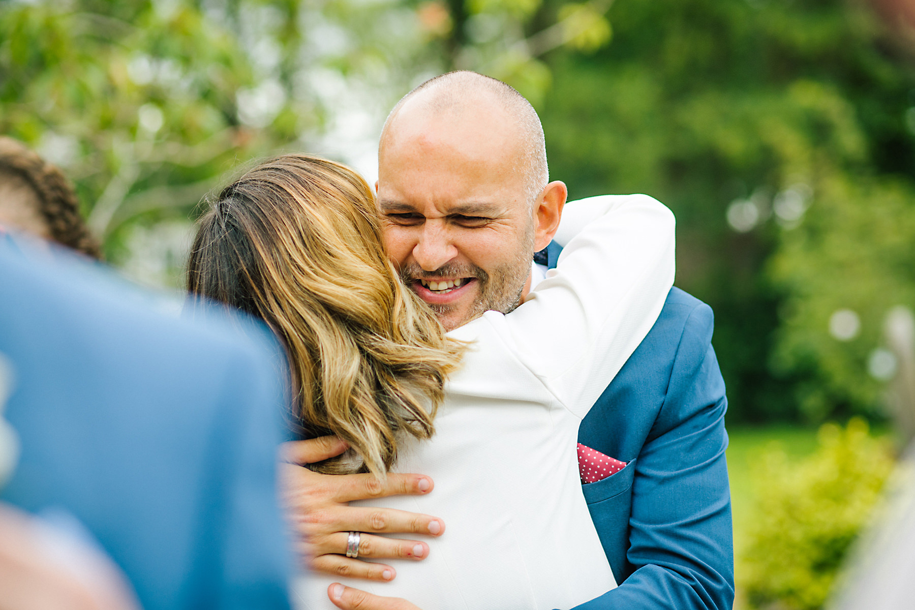 wedding guests hugging