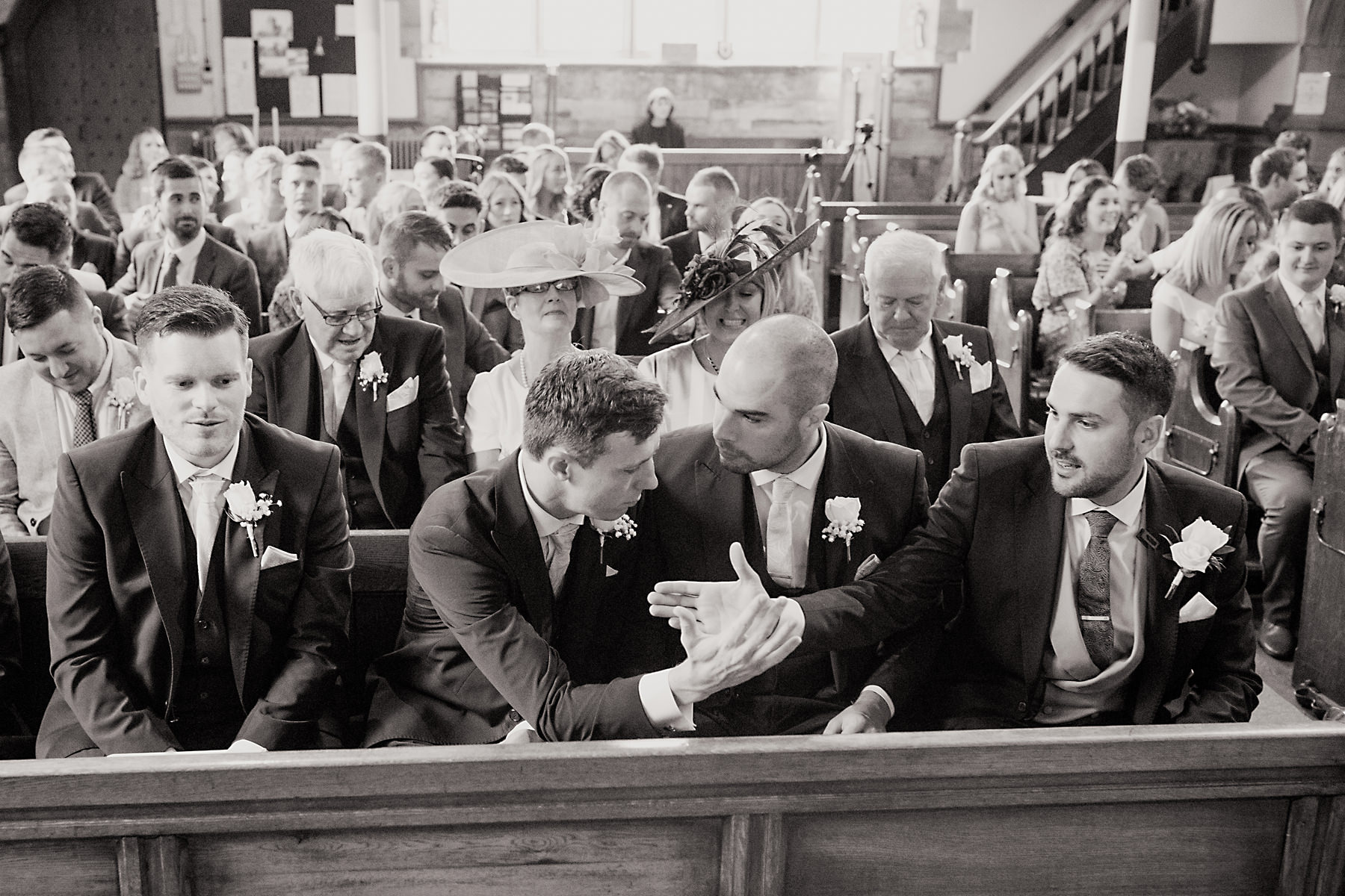 groom sat on church pew