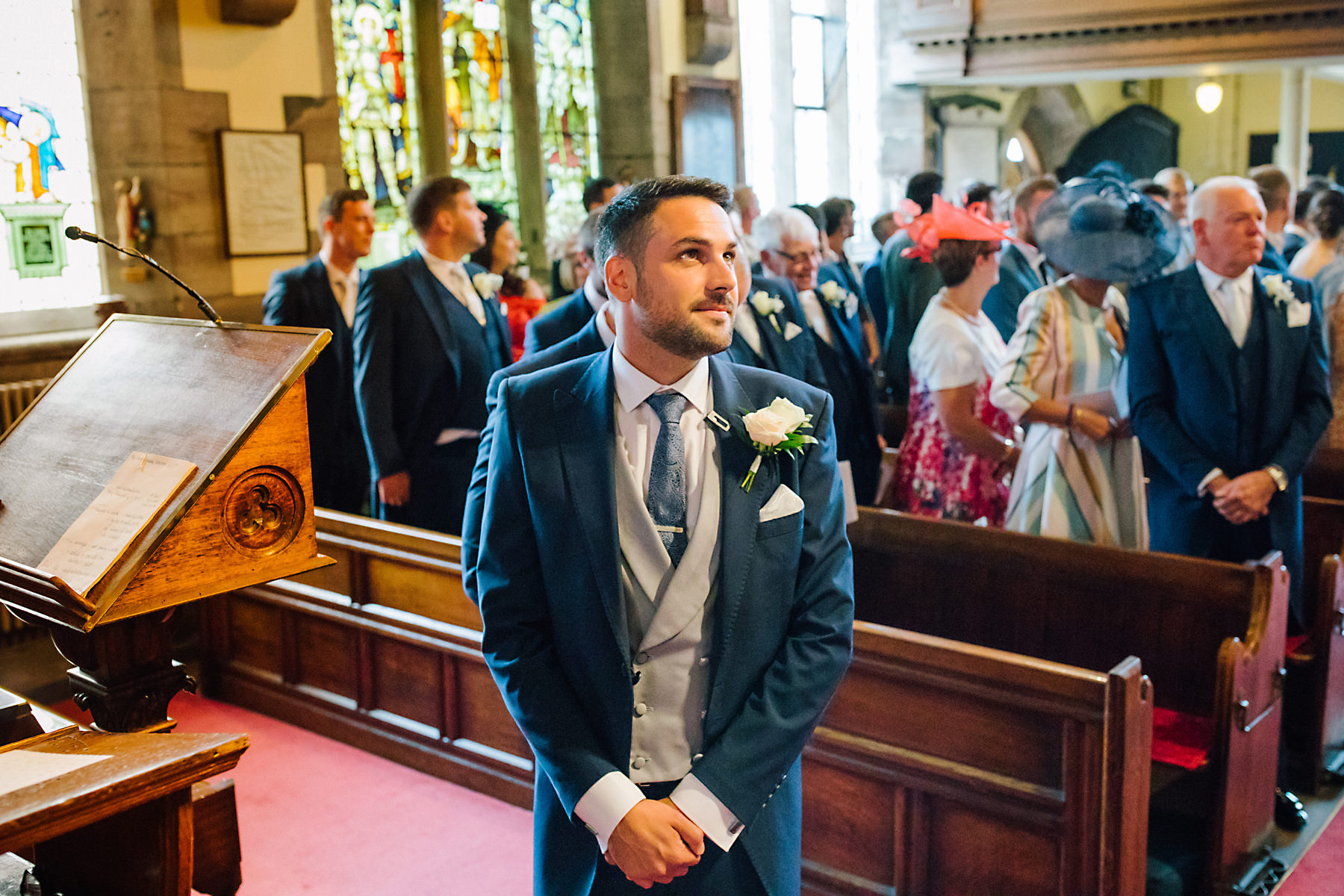 groom waiting at the top of the aisle