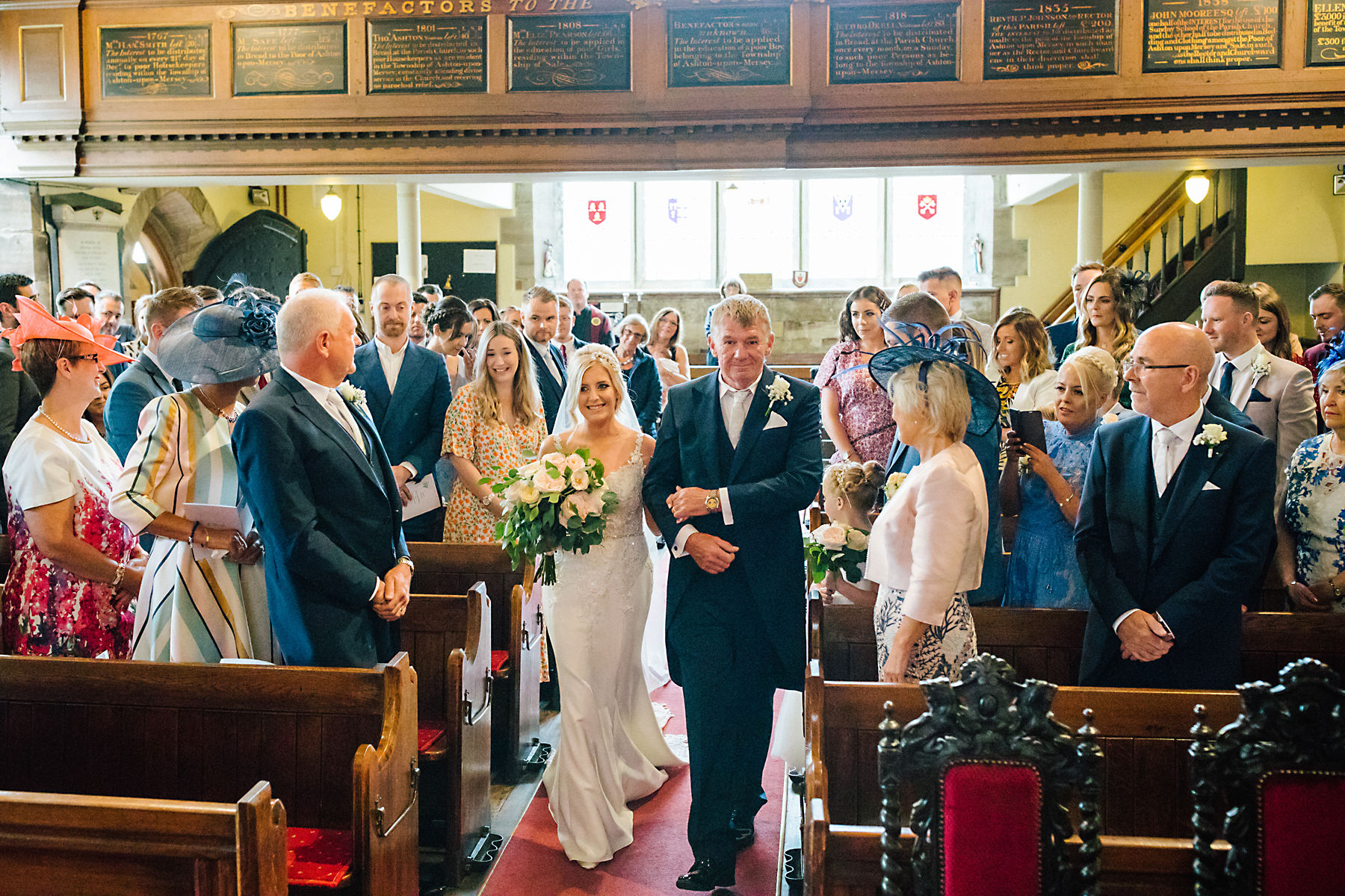 bride and dad walking down the aisle