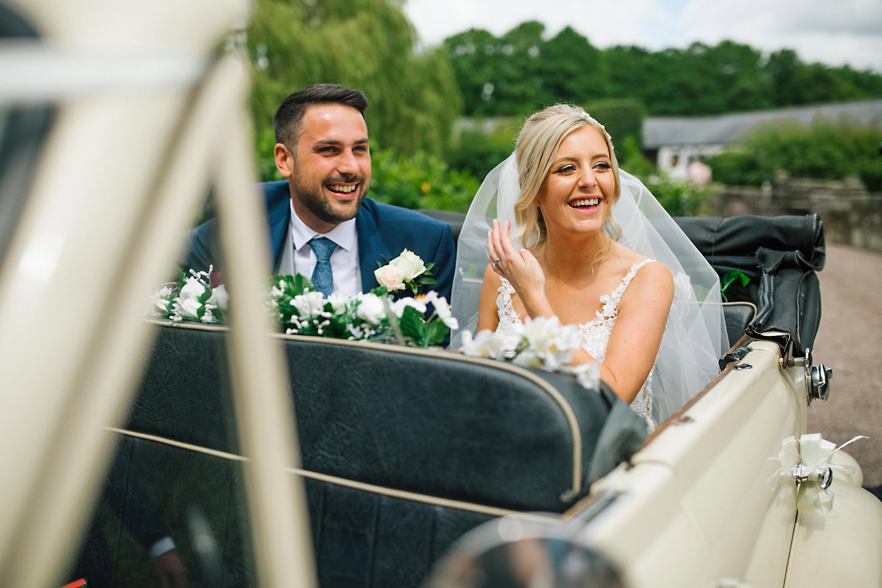 bride and groom in vintage wedding car