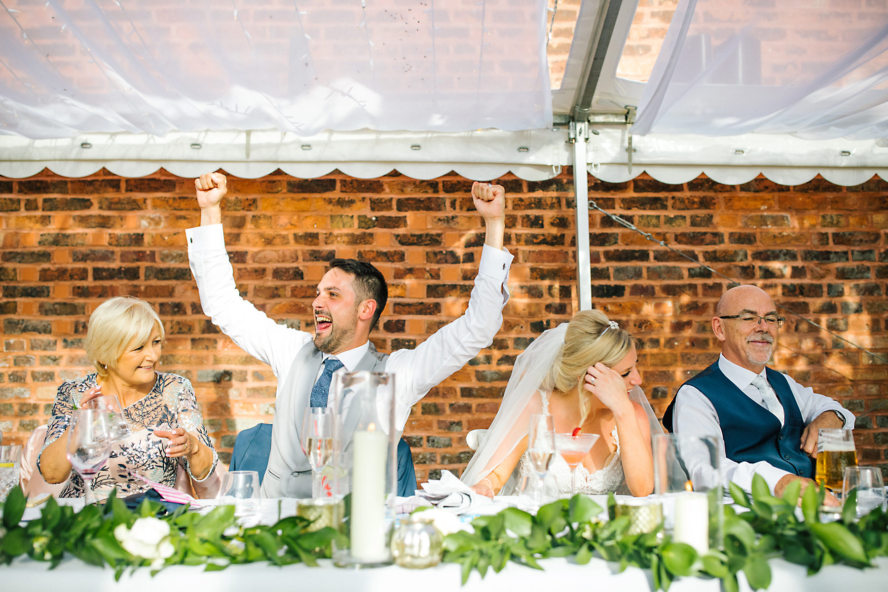 bride and groom laughing during speeches