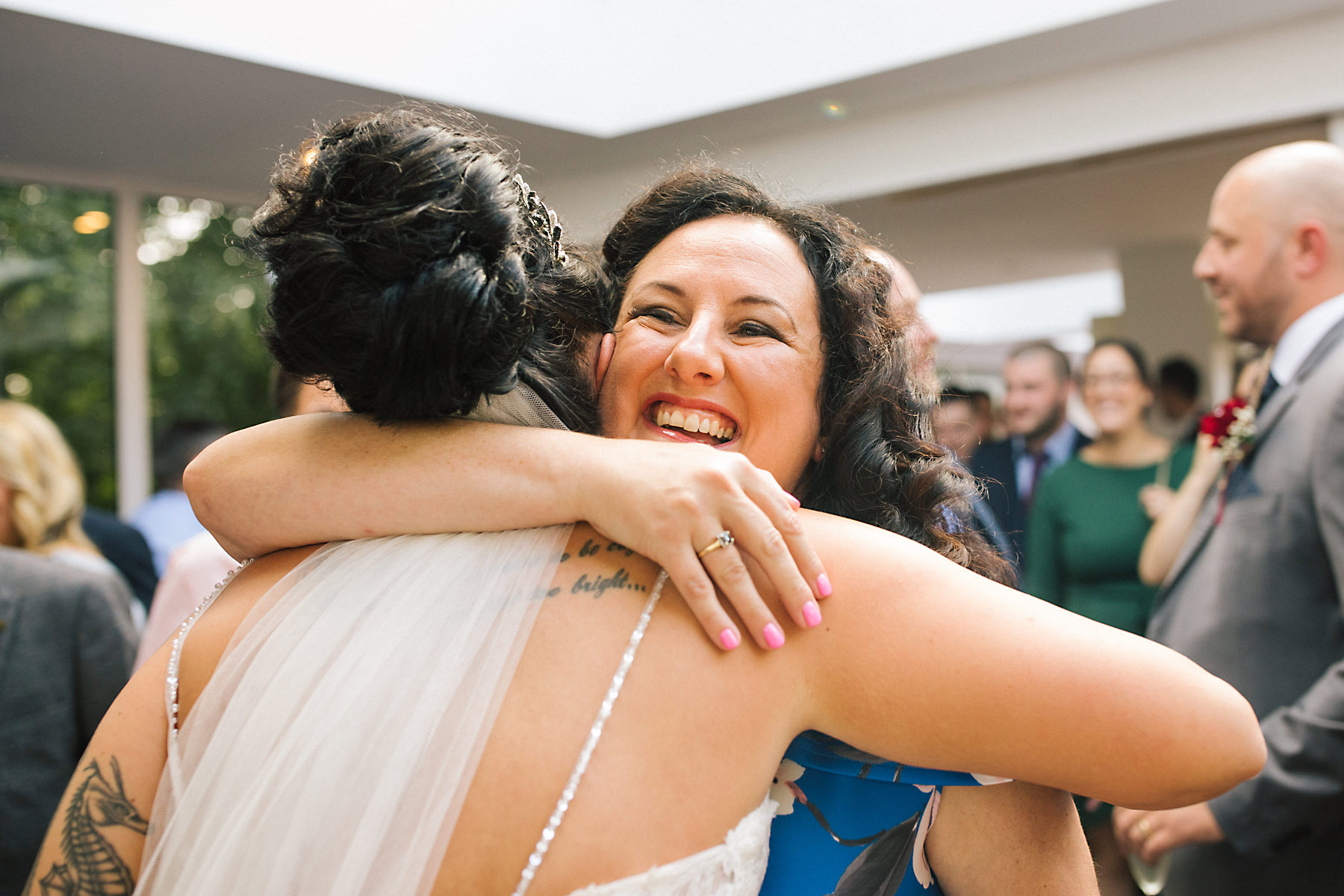 guests hugging at wedding