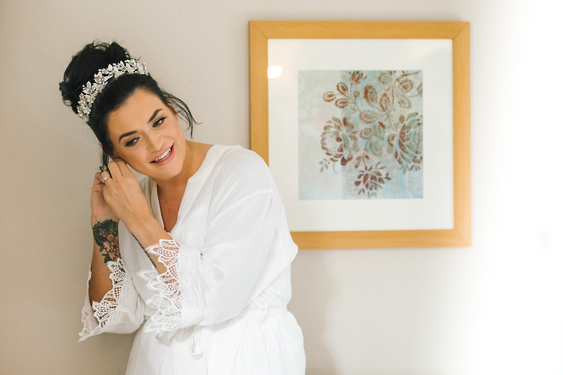 bride putting earrings in