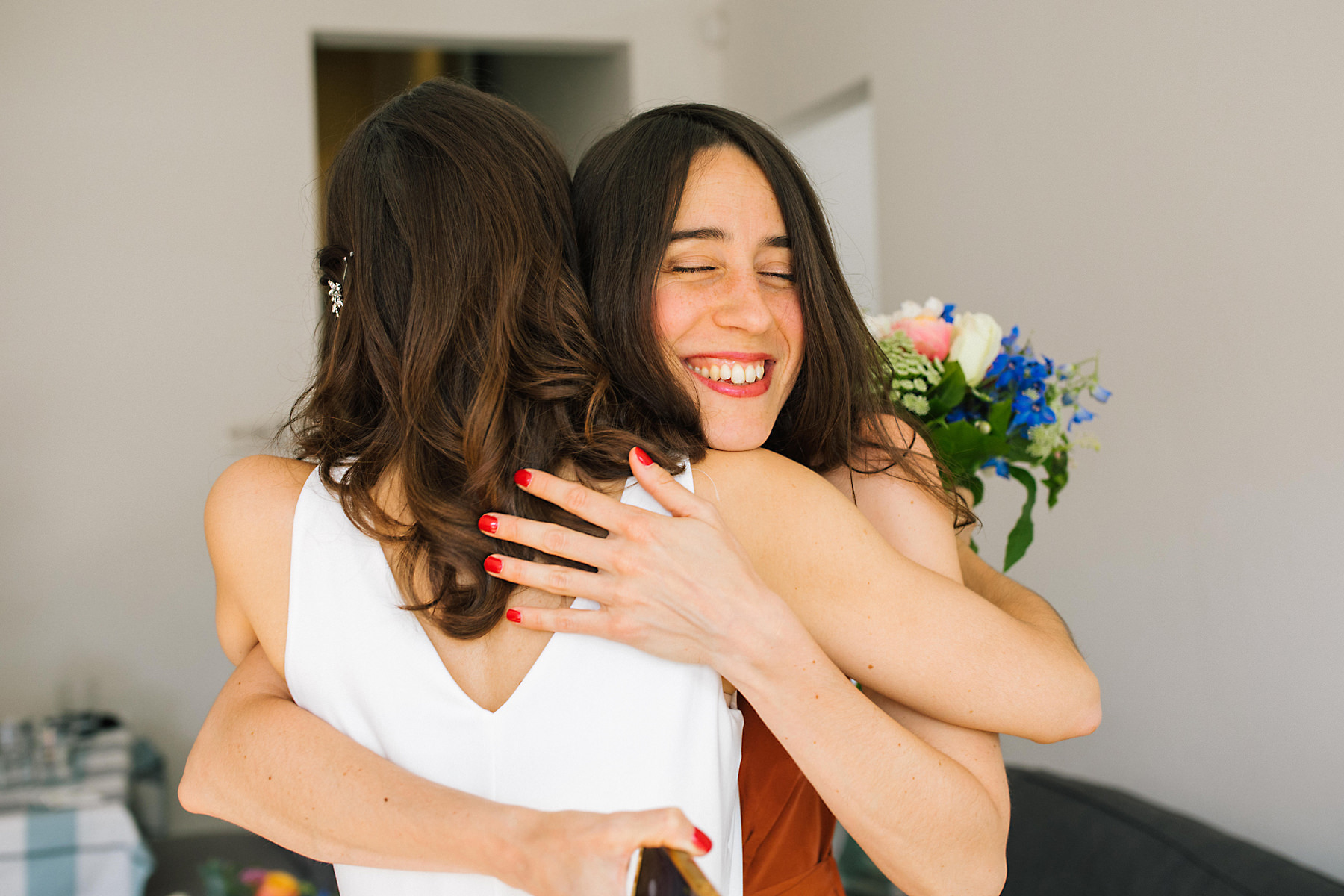 bride hugging sister