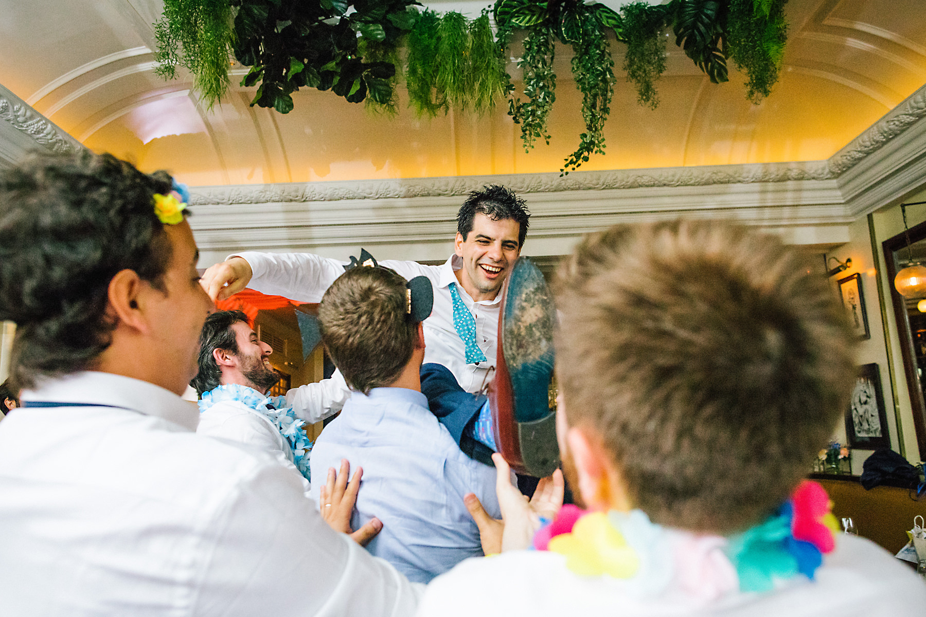 groom thrown in air at wedding