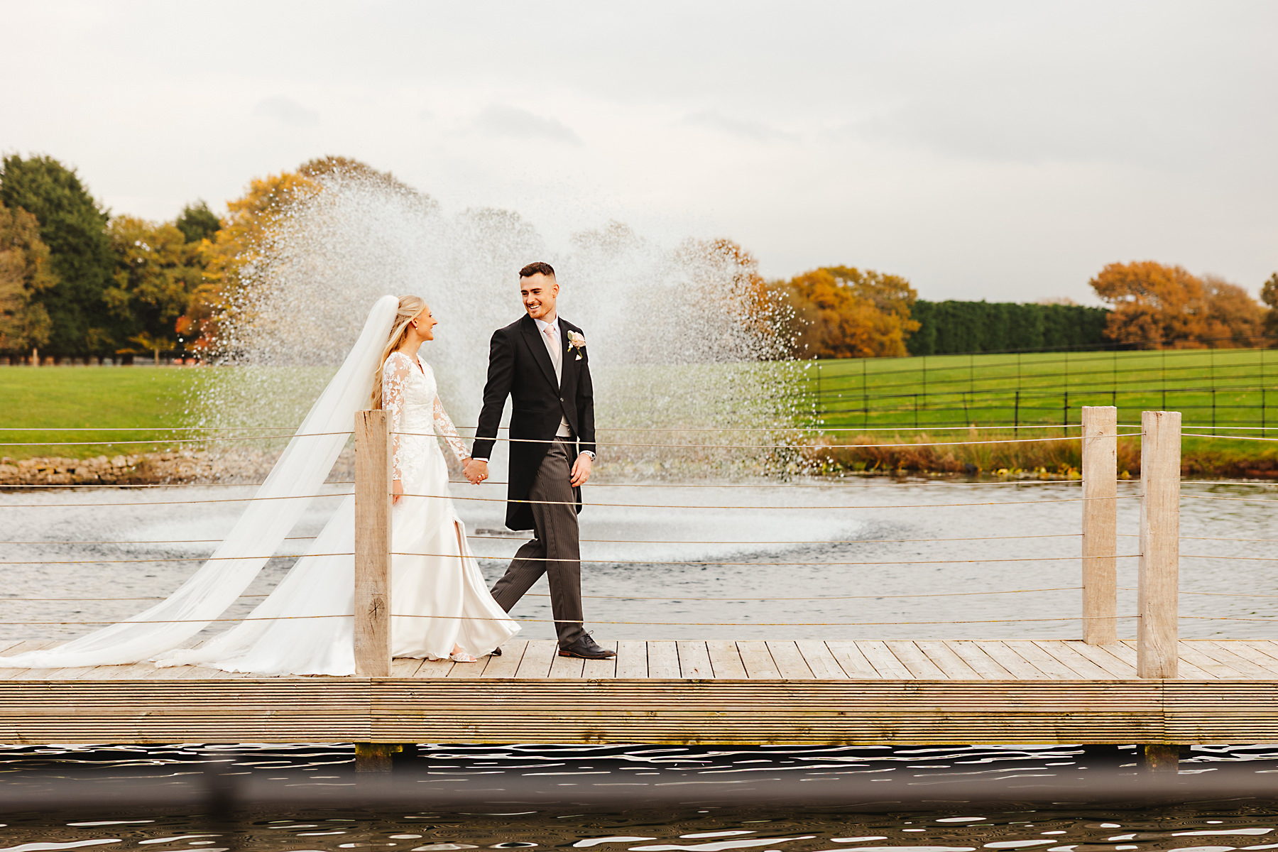 Bride and groom walking near the lake at Merrydale Manor